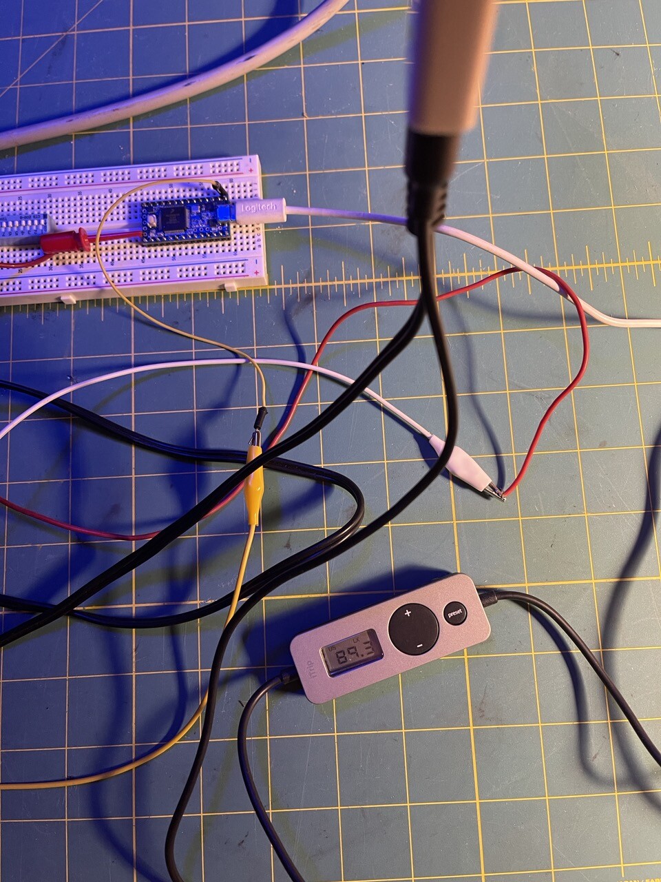 Wires, a small nano FM broadcaster, and a protoboard with a Teensy microcontroller. 